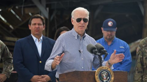 politics US President Joe Biden speaks in a neighborhood impacted by Hurricane Ian at Fishermans Pass in Fort Myers, Florida, on October 5, 2022 as Florida Governor Ron DeSantis looks on. (Photo by OLIVIER DOULIERY / AFP) (Photo by OLIVIER DOULIERY/AFP via Getty Images)