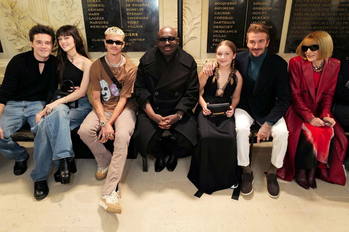 (From left to right) Brooklyn Peltz Beckham, Nicola Peltz Beckham, Romeo Beckham, Edward Enninful, Harper Beckham, David Beckham and Anna Wintour attend the Victoria Beckham Spring-Summer 2023 runway show during Paris Fashion Week.