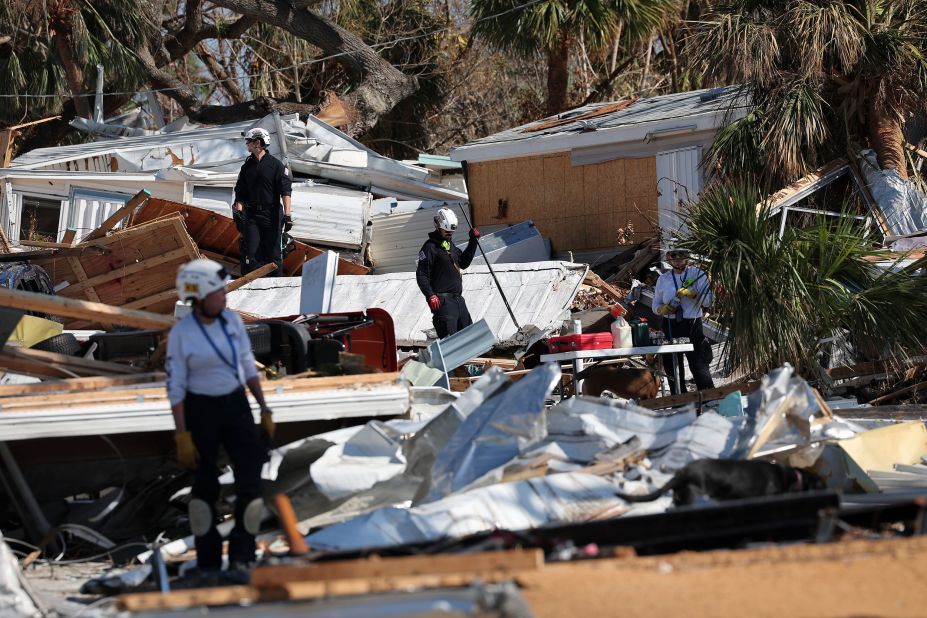 Members of a search-and-rescue team comb through the wreckage on Fort Myers Beach on Tuesday.