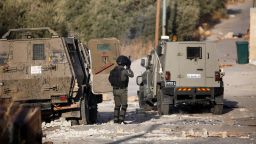 Palestinian youths and Israeli forces clash as troops surround a building in the village of Deir al-Hatab, east of Nablus in the West Bank.