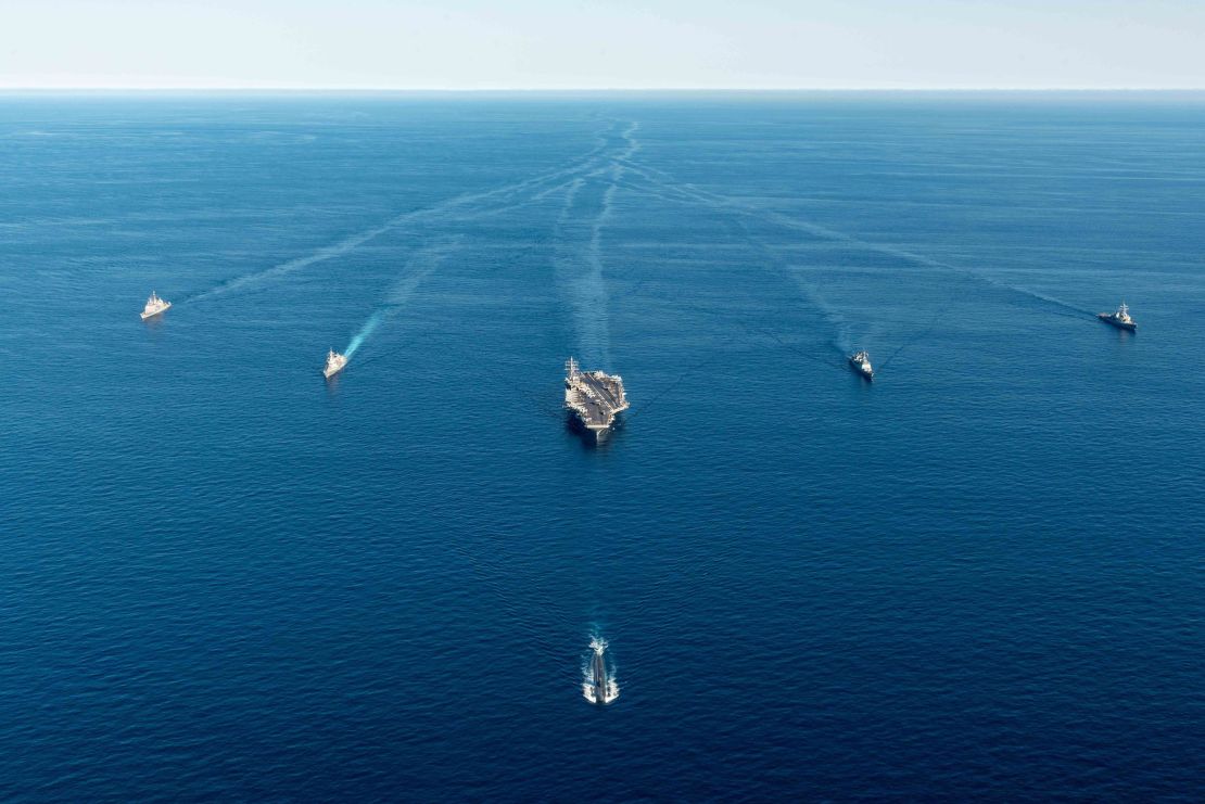 A US aircraft carrier and submarine, and South Korean and Japan warships, seen during a joint exercise on September 30.
