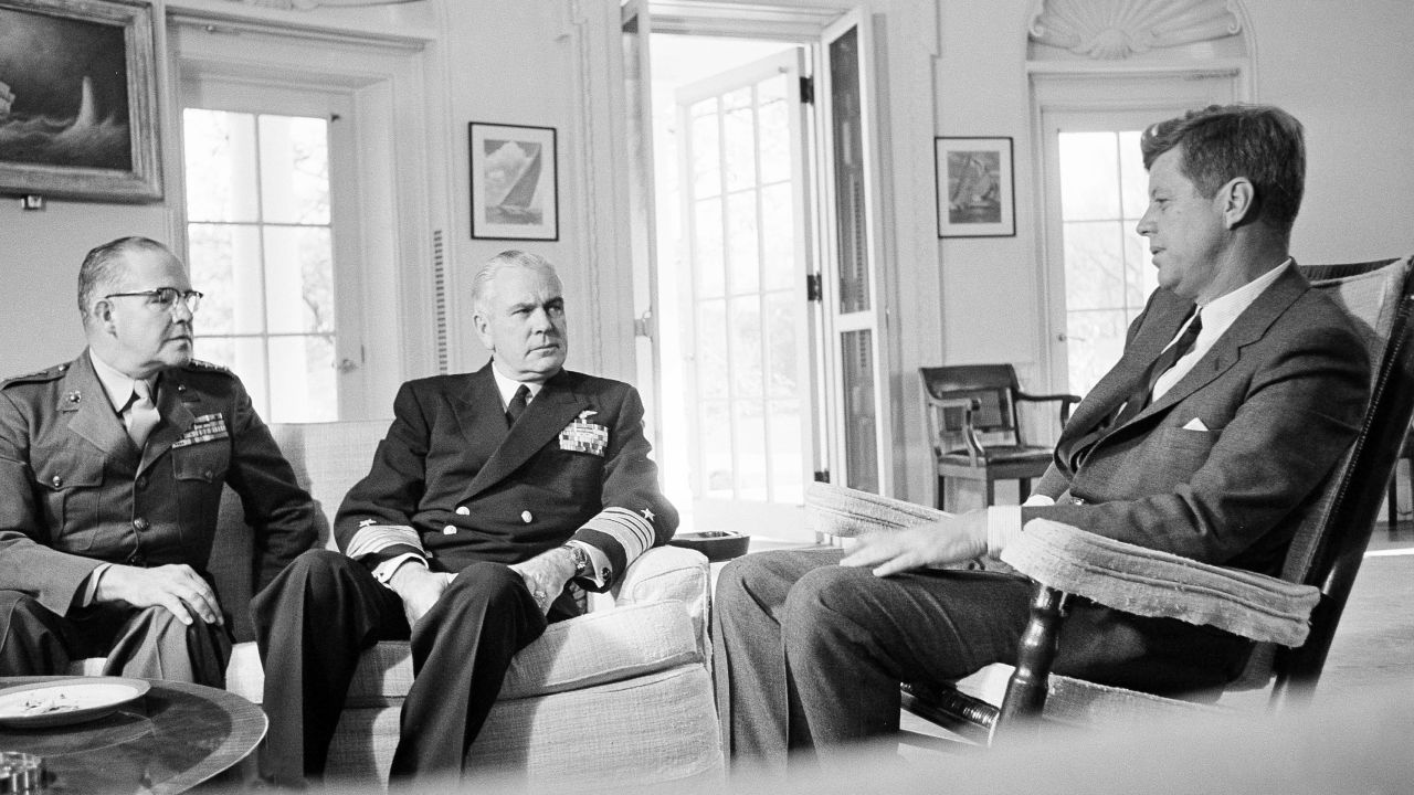 In this Oct. 29, 1962, file photo, President John F. Kennedy poses in the White House office with Gen. David Shoup, left, Marine Corps Commandant, and Adm. George Anderson, Chief of US Naval Operations in Washington.