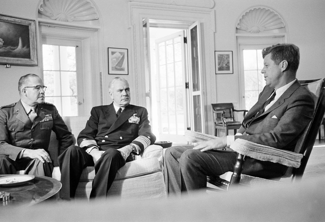 In this Oct. 29, 1962, file photo, President John F. Kennedy poses in the White House office with Gen. David Shoup, left, Marine Corps Commandant, and Adm. George Anderson, Chief of US Naval Operations in Washington. 