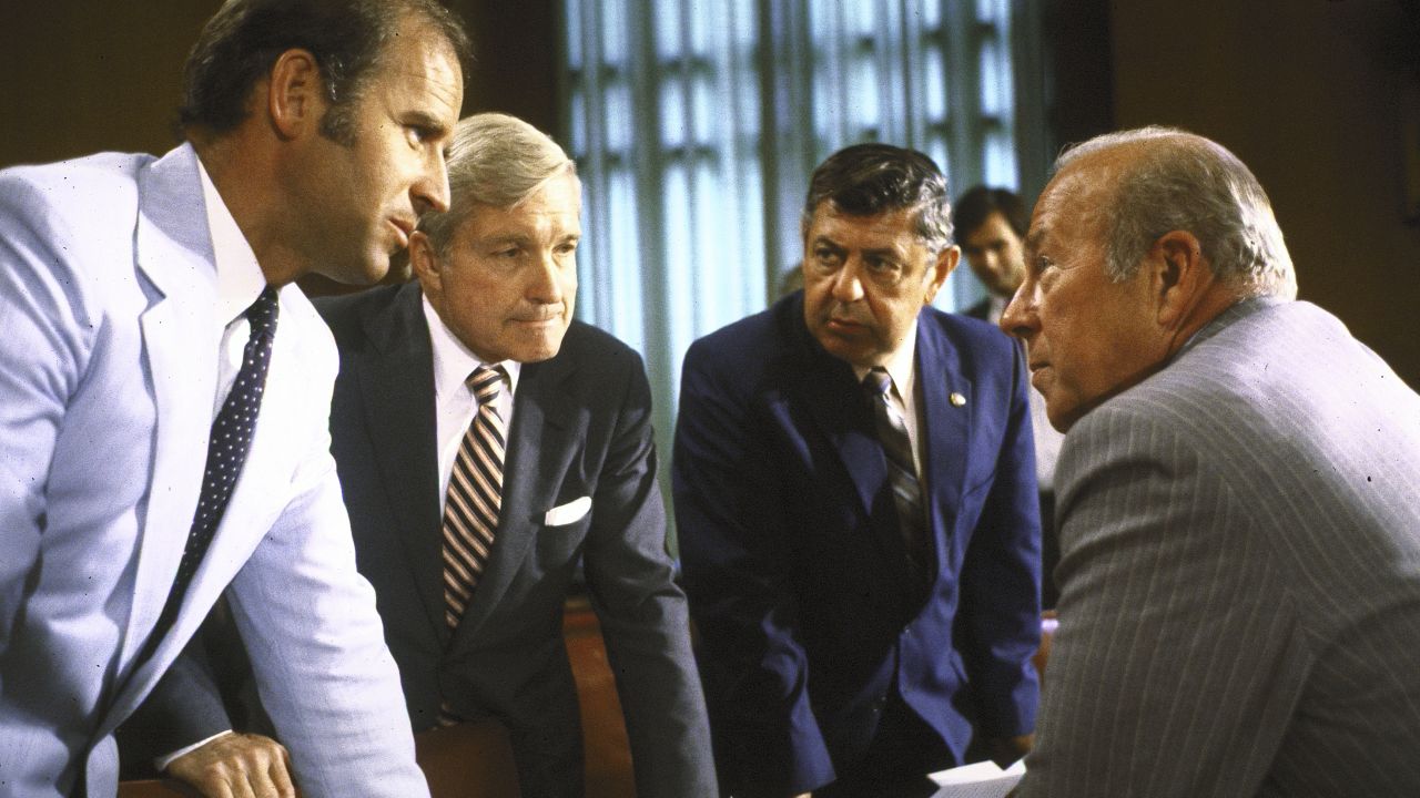 Secretary of State designate George Shultz (R) with Senators Percy (2L), Joe Biden (L) & Edward Zorinsky (2R) during his confirmation hearings before Senate Foreign Relations Committee.