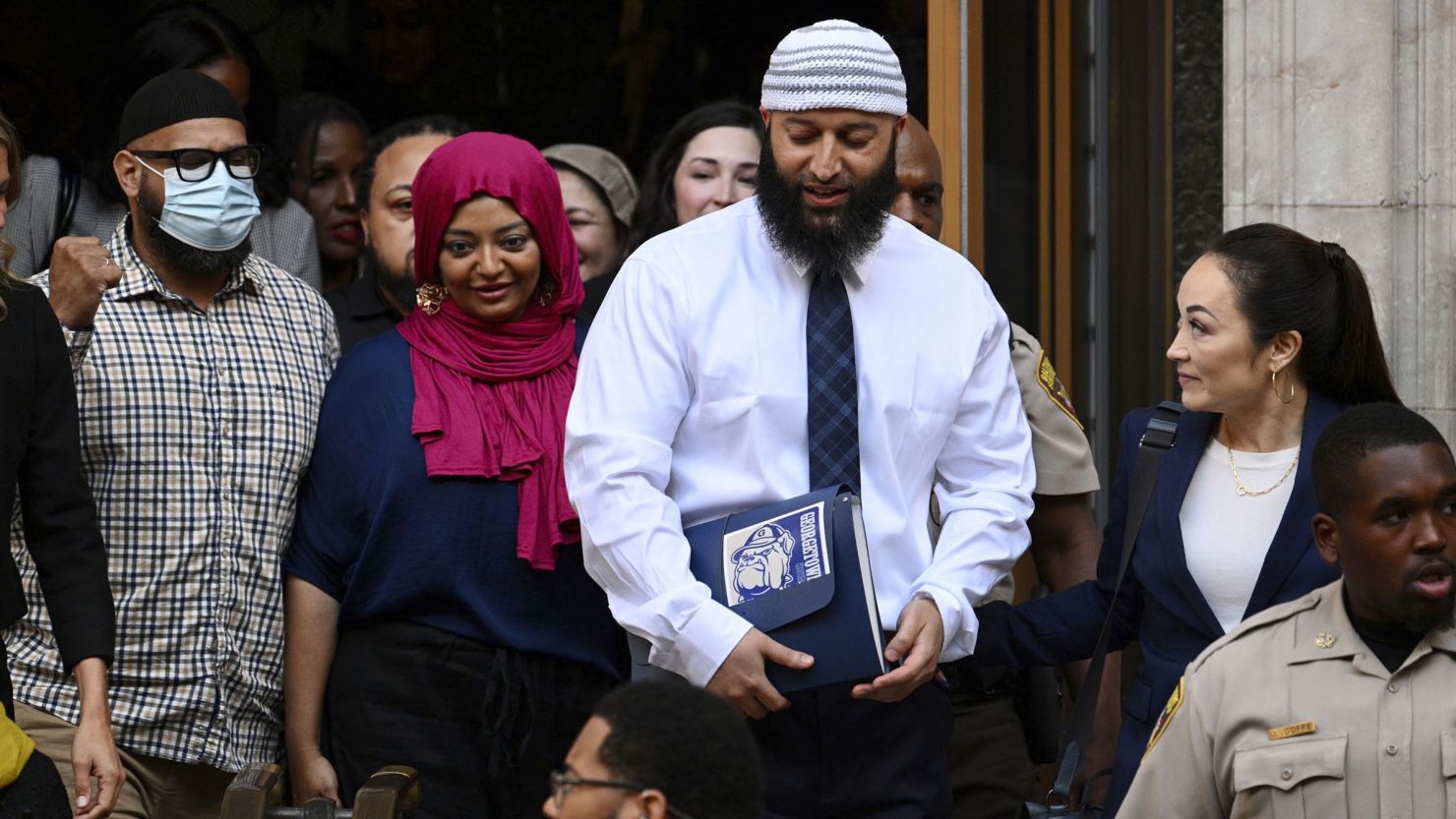 Adnan Syed, center right, leaves the courthouse after a hearing on Monday, Sept. 19, 2022, in Baltimore.