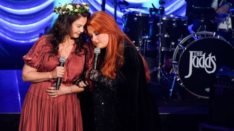 Ashley and Wynonna Judd share a moment on stage during the A River of Time Celebration in Nashville in May.