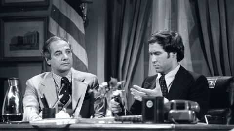 Chevy Chase (as Gerald Ford) at desk With Ron Nessen, Ford's real Press Secretary, on 'Saturday Night Live' in 1976. 