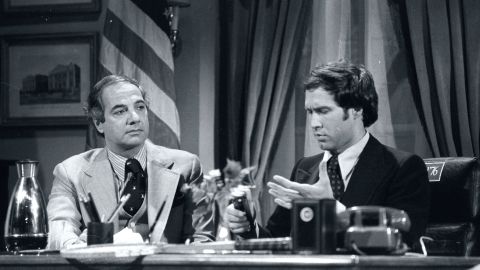 Chevy Chase (as Gerald Ford) at desk With Ron Nessen, Ford's real Press Secretary, on 'Saturday Night Live' in 1976.