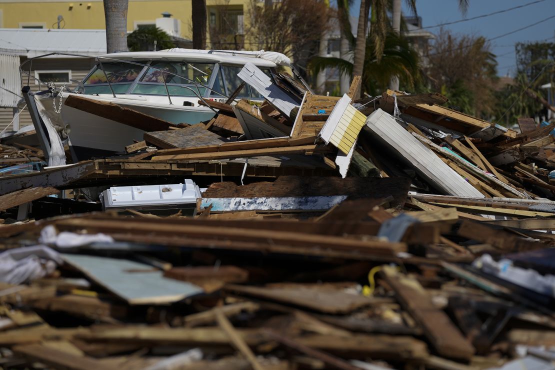 A powerboat lies atop a pile of debris two days after the passage of Hurricane Ian, in Fort Myers, Florida. 