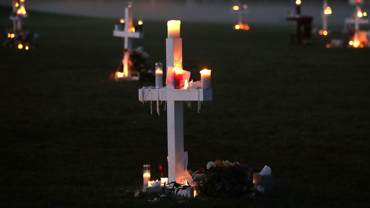 Candles glow at a memorial site to honor 17 people who were killed in the shooting at Marjory Stoneman Douglas High School in Parkland, Florida.