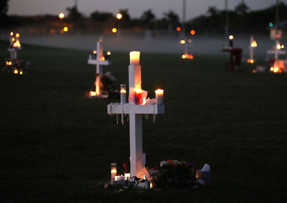 Candles glow at a memorial site to honor 17 people who were killed in the shooting at Marjory Stoneman Douglas High School in Parkland, Florida.