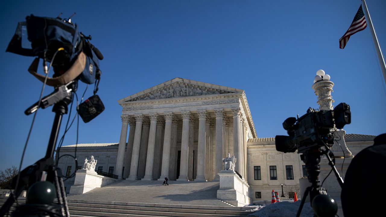 Members of the media setup cameras outside the Supreme Court in Washington, DC, on January 27, 2022. 