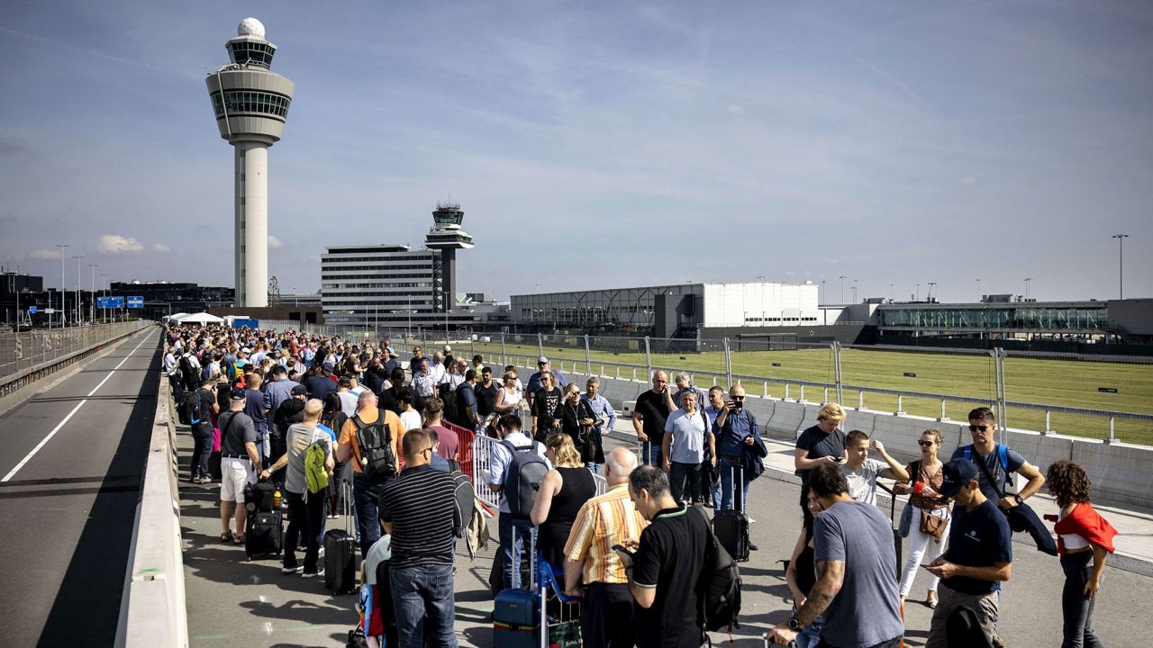 Travelers queue at Schiphol Airport, on September 12, 2022.