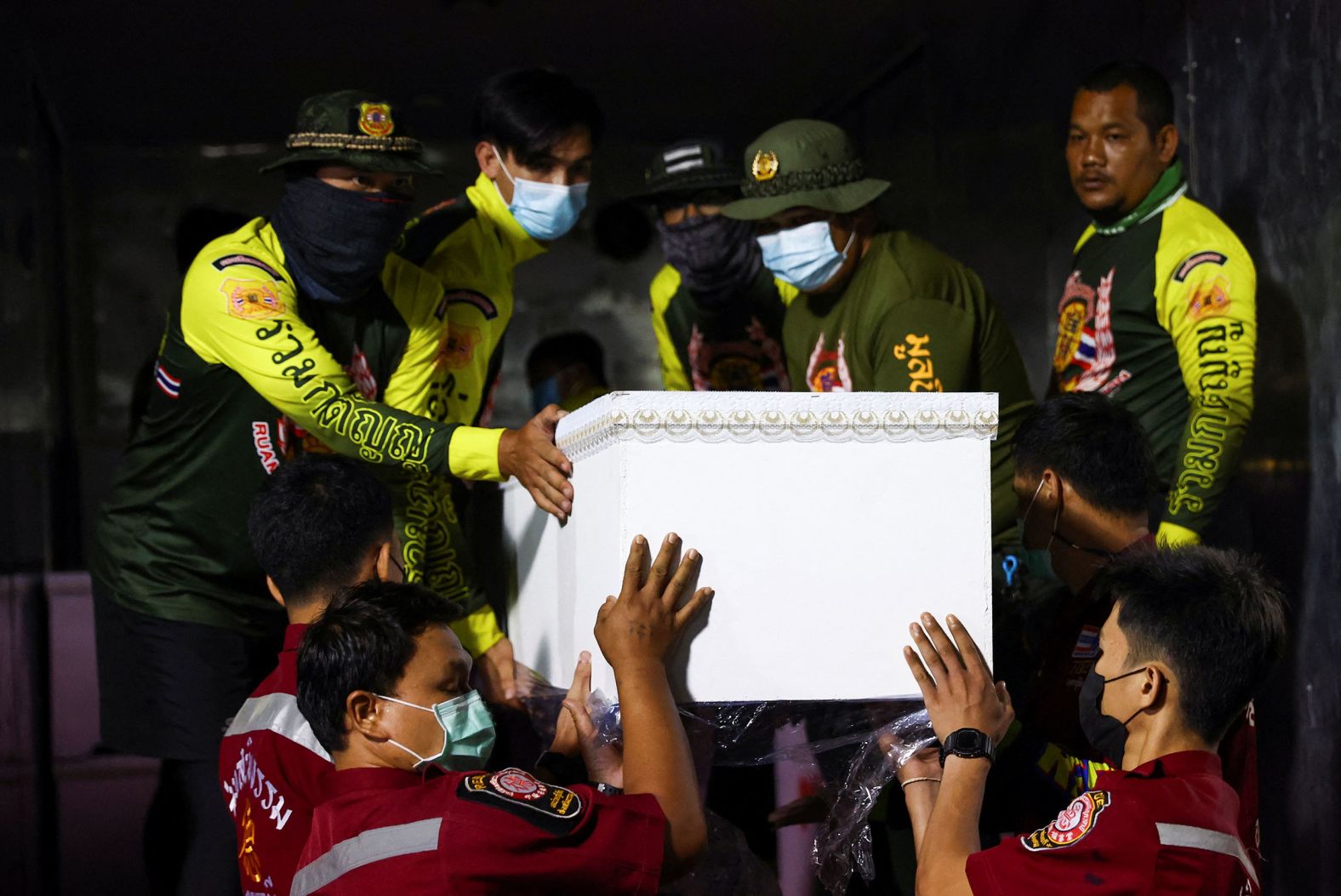 Rescue workers carry coffins containing the bodies of victims outside a hospital after a <a href="https://www.cnn.com/2022/10/06/asia/thailand-mass-shooting-intl-hnk/index.html" target="_blank">massacre at a child care center</a> in northeastern Thailand on Thursday, October 6. Dozens of children were among the victims.