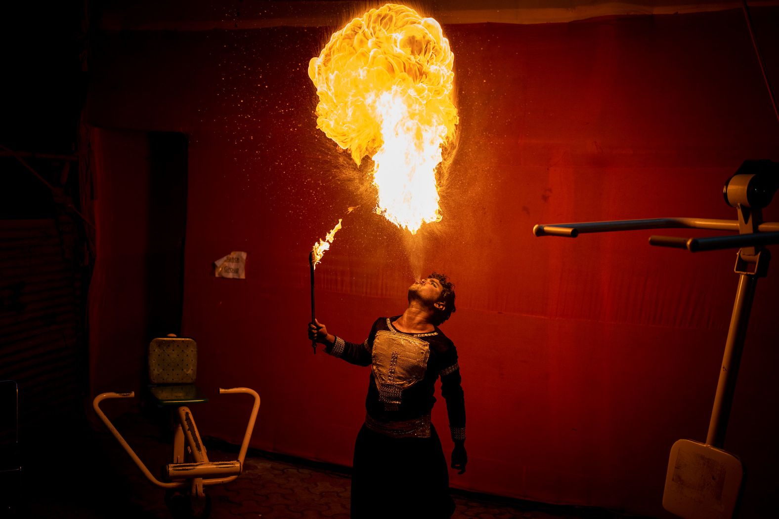 An artist practices spitting fire backstage before a performance during the Dussehra festival in New Delhi, India, on Wednesday, October 5. 