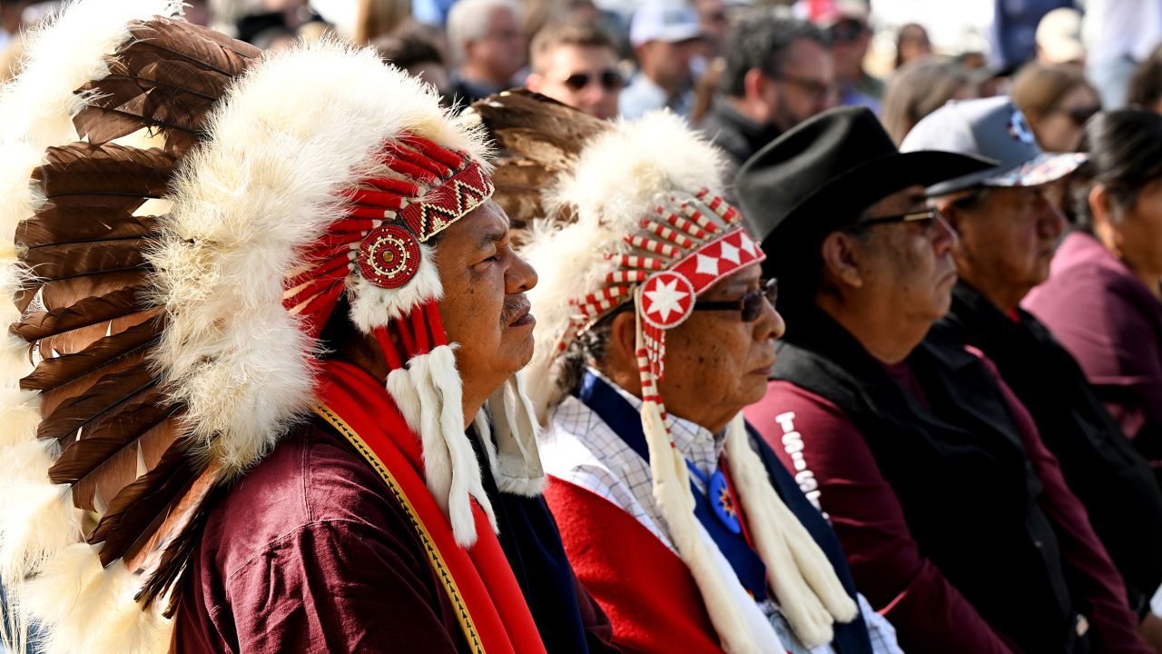 Anthony Spottedwolf, left, his father Patrick Spottedwolf, center, and Chester Whiteman, right, all tribal chiefs and members of the Northern Cheyenne, listen to an opening prayer given by Victor Orange of the Cheyenne and Arapaho Tribes during a gathering at the Sand Creek Massacre National Historic site on Wednesday.
