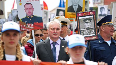 Andrei Kartapolov, center, holds a portrait of Russian army officer who was killed during a military conflict in Ukraine, on May 9, the 77th anniversary of the victory over Nazi Germany in World War II, in Volgograd, Russia.