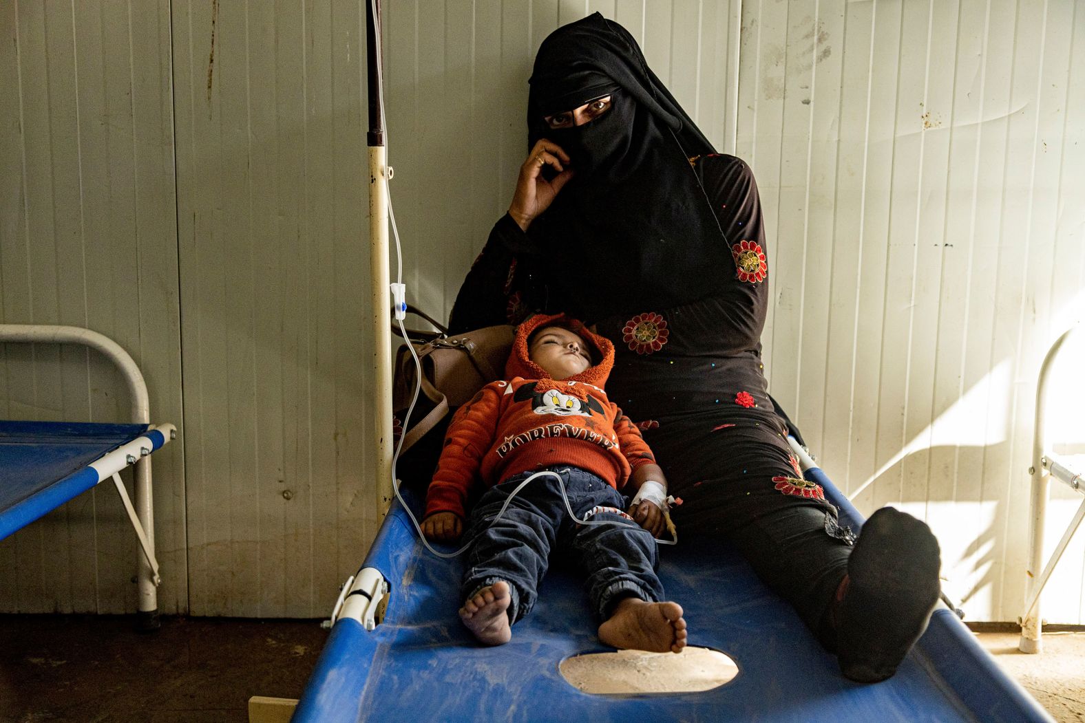 A mother sits with her child who was diagnosed with cholera in a hospital in Deir el-Zour, Syria, on Thursday, September 29. The UN and Syria's Health Ministry have said the source of the outbreak is believed to be linked to people drinking unsafe water from the Euphrates River and using contaminated water to irrigate crops, resulting in food contamination.