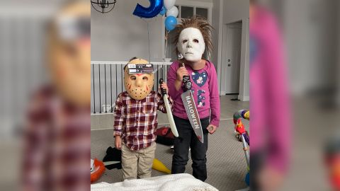 Dominic (left) and Aubriella Lopez proudly display their Michael Myers masks. The pair are major "Halloween" fans, their mother, Kayla, tells CNN.