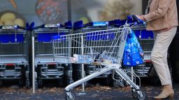 A customer pushes a shopping cart and bags outside a supermarket operated by Aldi Einkauf GmbH & Co., also known as Aldi Nord, in central Berlin, Germany, on Tuesday, Oct. 4, 2022. 
