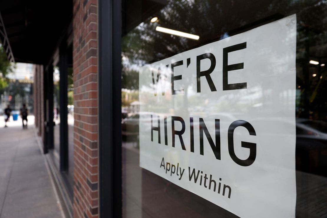 A hiring sign posted on the window of a retail store in Washington, D.C.