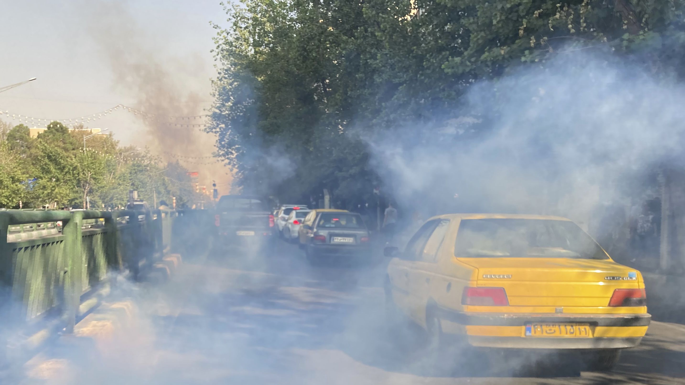 Tear gas is fired by security to disperse protesters in front of Tehran University on October 1.