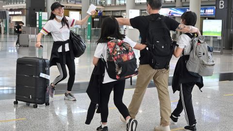 Family members greet each other after arriving at Hong Kong's international airport on September 27, 2022.