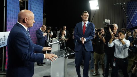 Arizona Democratic Sen. Mark Kelly, left, and his Republican challenger Blake Masters, right, pause on stage prior to a televised debate in Phoenix, Thursday, Oct. 6, 2022. 