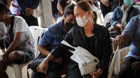 Families of victims mourn while waiting for blessings from Buddhist monks on October 7, 2022.