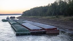 Barges idle while waiting for passage in the Mississippi River near Vicksburg, Miss., on Tuesday, Oct. 4, 2022. T