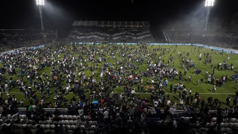Fans spilled onto the pitch as the game was abandoned after unrest inside the stadium. 