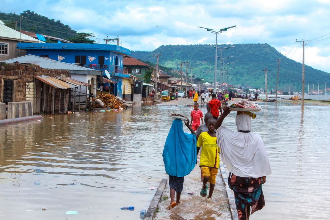 People stranded due to floods following several days of downpours In Kogi Nigeria, Thursday, Oct. 6, 2022. 