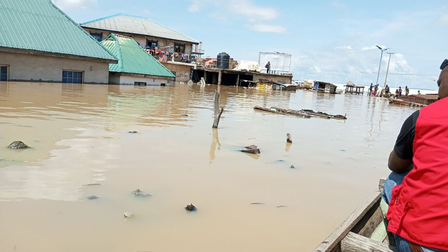 An official of the Nigerian Red Cross Society canoes through a submerged market in Lokoja, capital of north-central Kogi state on September 27, 2022.