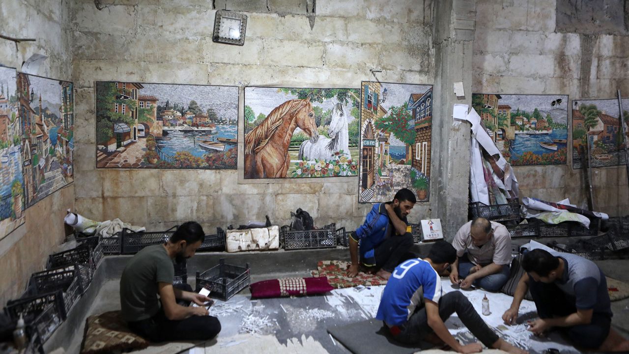 Syrian employees at a mosaic workshop prepare panels in the rebel-held town of Dana, in the northwestern Idlib province, near the Turkish-Syrian border on Thursday.
