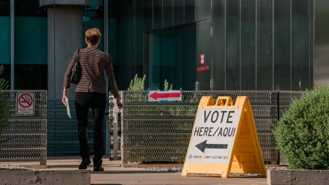 A voter arrives to a polling location at the Burton Barr Central Library in Phoenix, Arizona, US, on Tuesday, Aug. 2, 2022. 