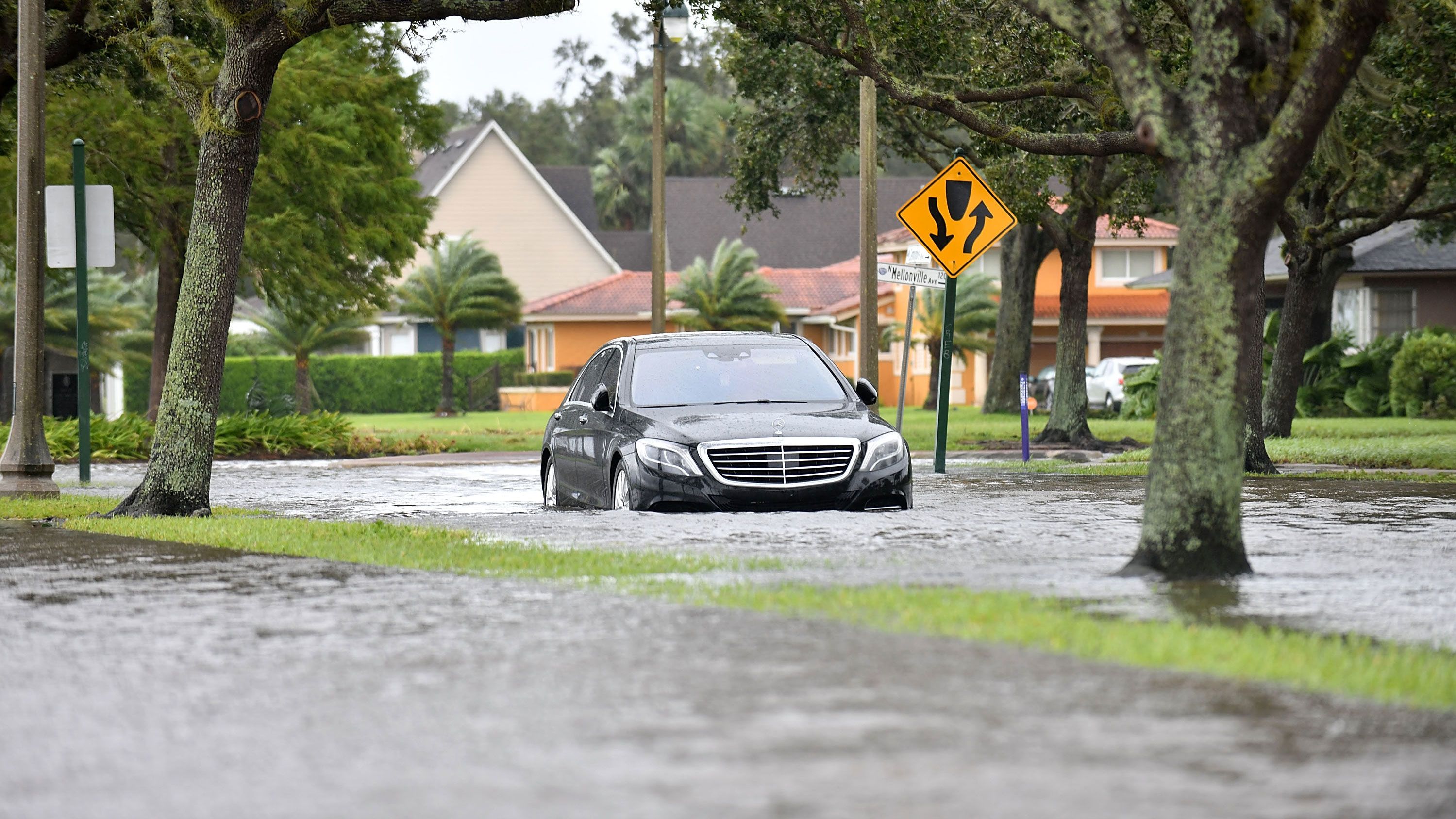A car is seen in a flooded road after being hit by the winds and rain from Hurricane Ian on September 29, 2022 in Sanford, Florida, located in Seminole County.