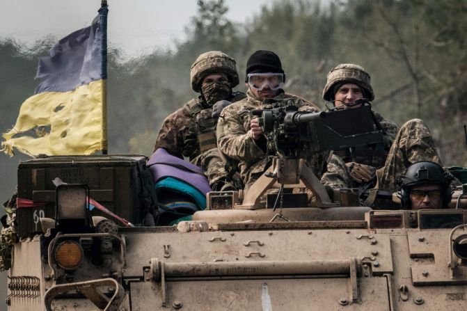 Ukrainian soldiers ride on an armored vehicle near the recently retaken town of Lyman in Donetsk region on October 6, as the <a href="index.php?page=&url=https%3A%2F%2Fedition.cnn.com%2F2022%2F10%2F04%2Feurope%2Frussia-ukraine-annexation-intl%2Findex.html" target="_blank">Ukrainian military continues to advance</a> into several of the areas Russia now claims as its own.