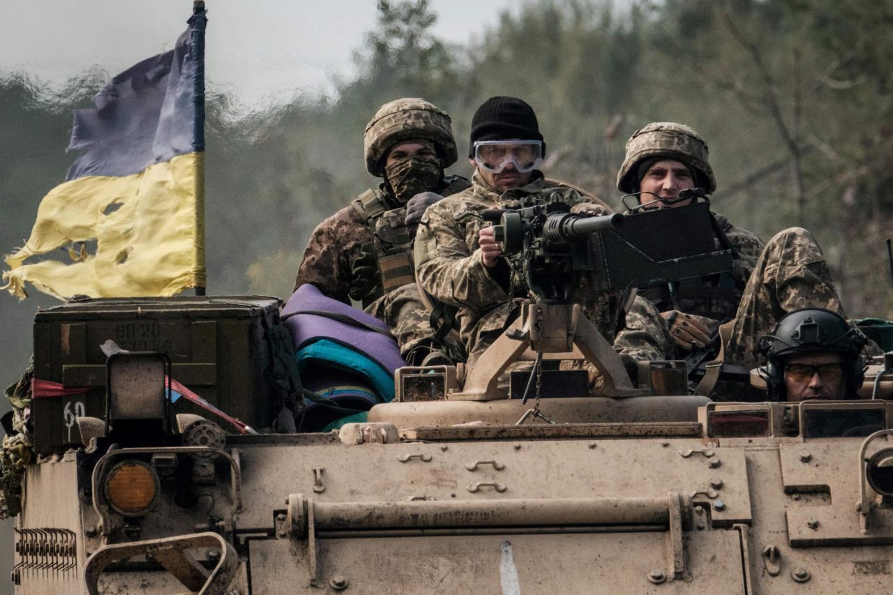 Ukrainian soldiers ride on an armored vehicle near the recently retaken town of Lyman in Donetsk region on October 6, as the <a target=