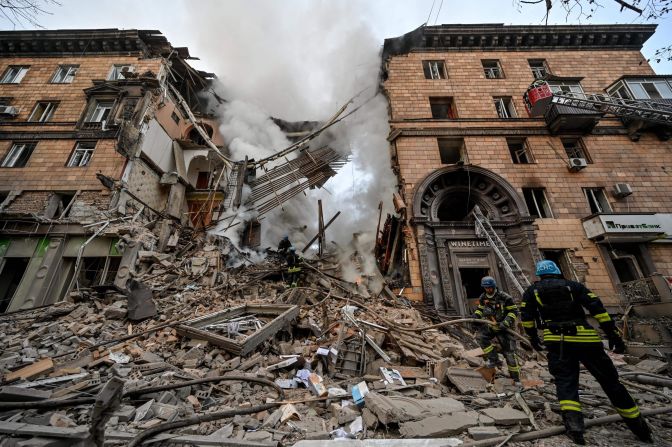 Ukrainian firefighters attend to the site of a missile strike in Zaporizhzhia, Ukraine, on October 6.