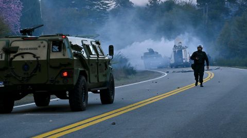 Police fire tear gas a they work to evict Mapuche Indigenous people from land they have been occupying for years near Villa Mascardi, Argentina, Tuesday, Oct. 4, 2022.