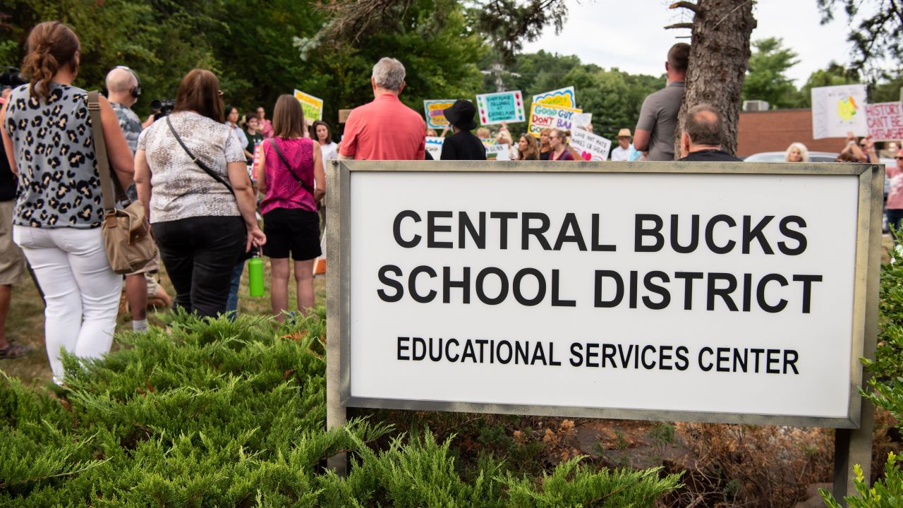 A large crowd gathered outside the Central Bucks School District administrative building in Doylestown Township for a press conference held  in July prior to a school board meeting, where speakers voiced opposition to a proposed library policy, which opponents called a pathway to book bans.