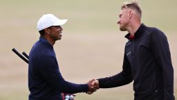 ST ANDREWS, SCOTLAND - JULY 12: Adrian Meronk of Poland and Tiger Woods of The United States interact on the 18th during a practice round prior to The 150th Open at St Andrews Old Course on July 12, 2022 in St Andrews, Scotland. (Photo by Harry How/Getty Images)