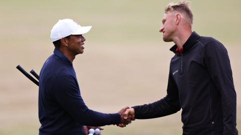 Adrian Meronk greets Tiger Woods during a practice round prior to The 150th Open at St Andrews, Scotland in July, 2022.