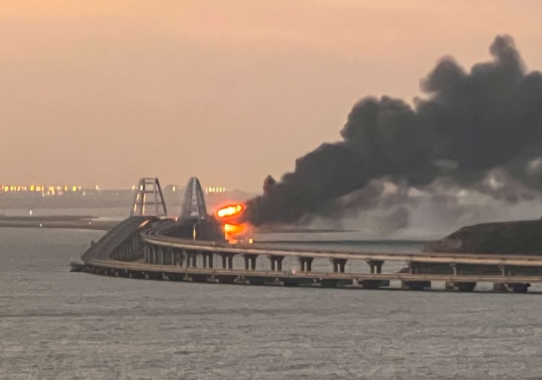 Smoke billows from fire on the Kerch bridge at sunrise on Saturday. 