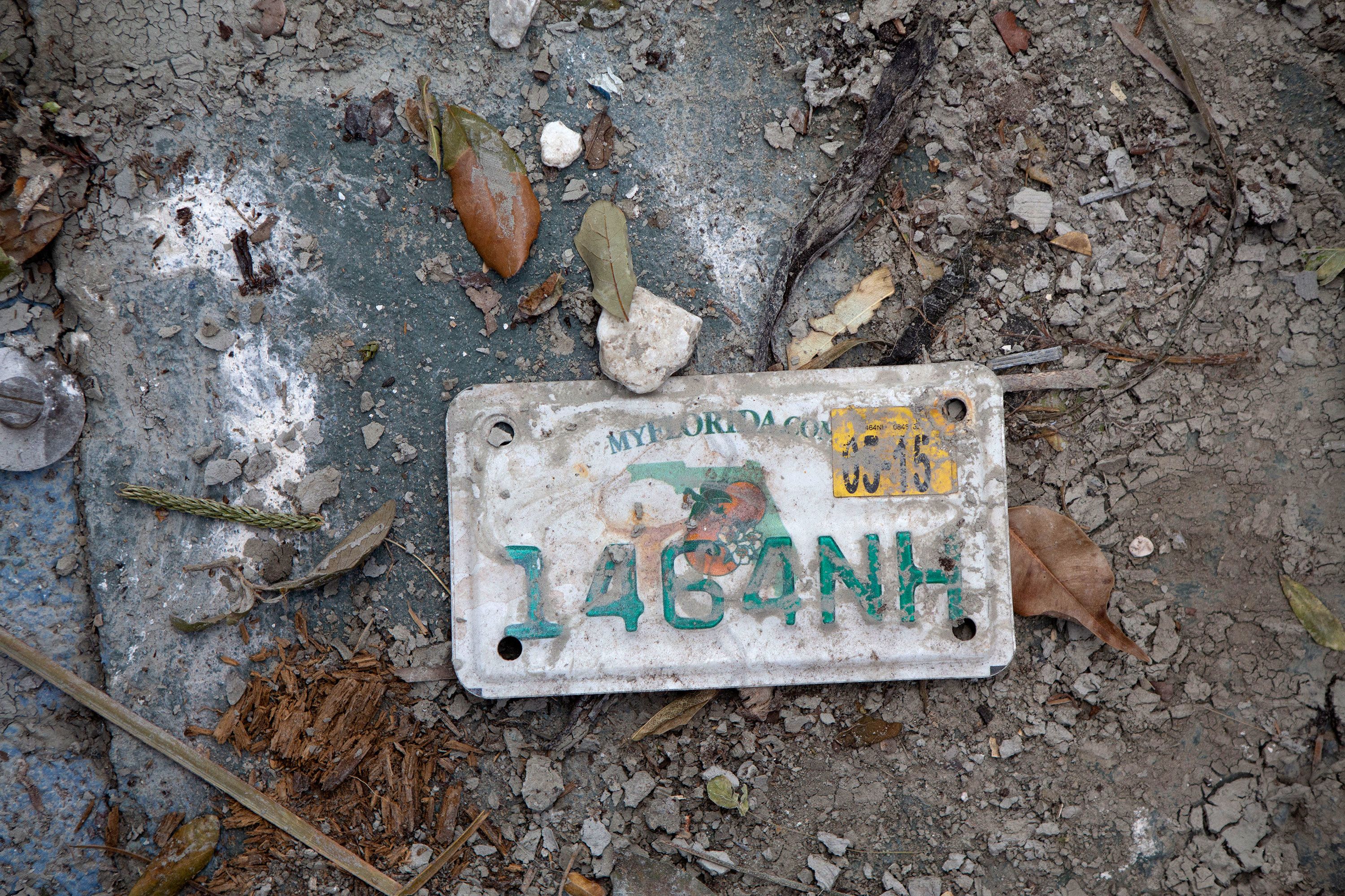 A license plate from a motorized scooter that was swept away by Ian's storm surge is seen on San Carlos Island.