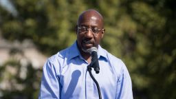 Senator Rev. Raphael Warnock speaks to supporters during his campaign tour, outside of the Liberty Theater on October 8, 2022 in Columbus, Georgia.