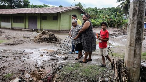 Residents leave their house at the former banana fields of the municipality of El Progreso before the arrival of tropical storm Julia, on October 8, 2022. 