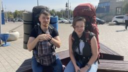 Married couple sitting outside Almaty train station with backpacks: computer programmer Sergei, 30 and his wife Irina, 27 (Rebecca Wright/CNN)