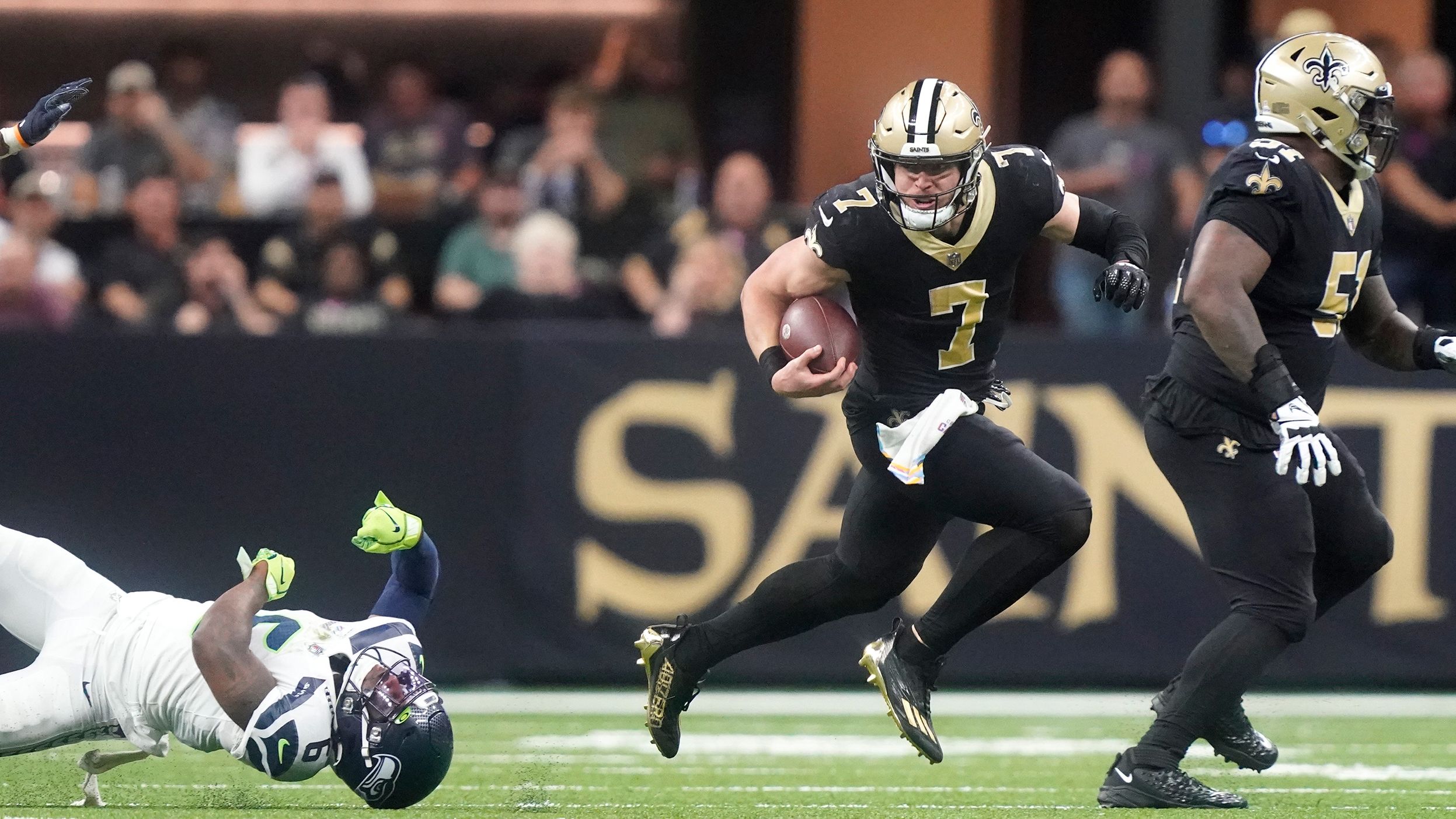 New Orleans Saints utility player Taysom Hill breaks the tackle of Seattle Seahawks safety Quandre Diggs and runs to the endzone for a 60-yard rushing touchdown during the Saints' 39-32 victory. Hill ran for three touchdowns, as well as throwing for another, as the Saints ended a three-game losing streak.