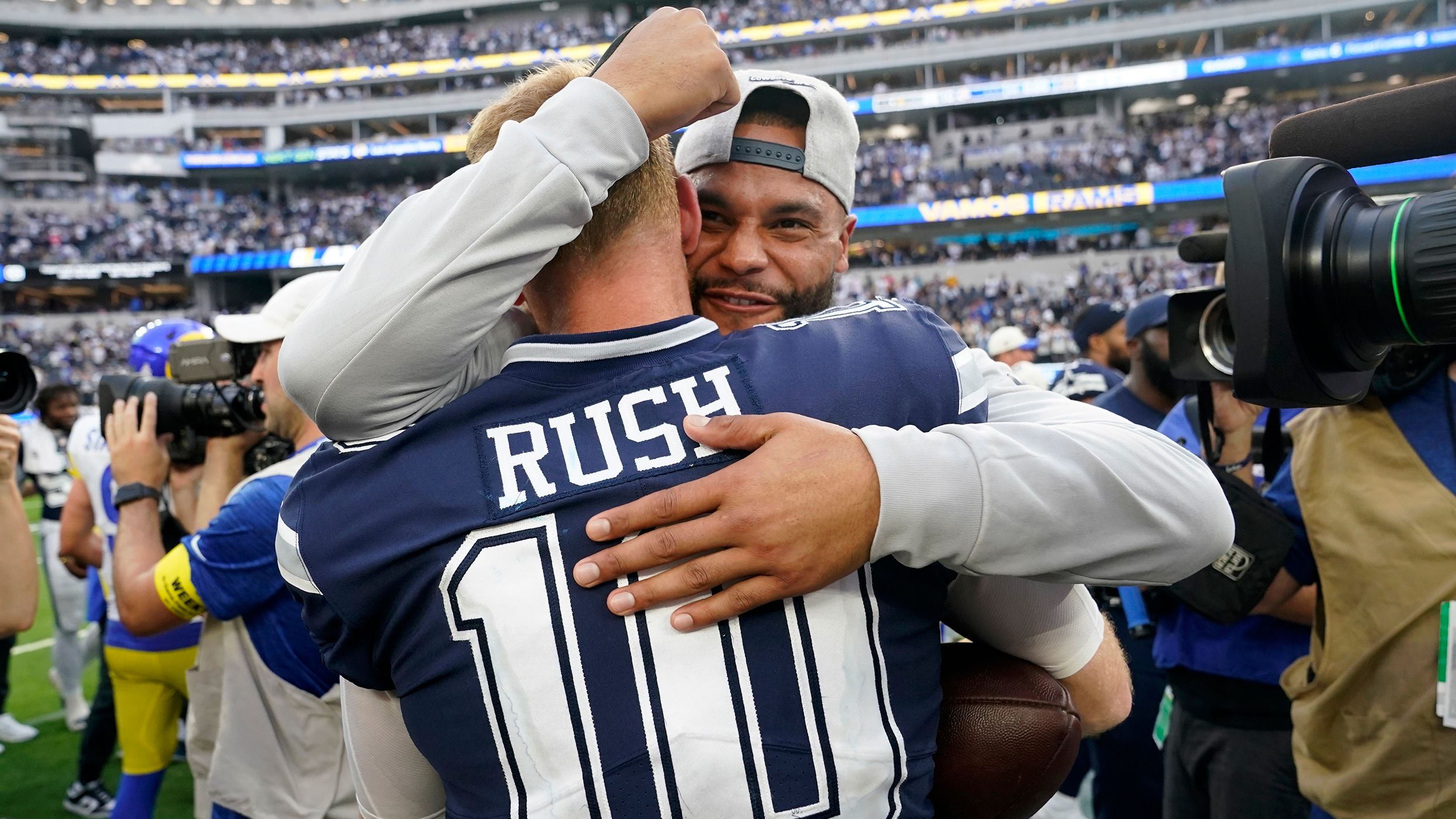 Dallas Cowboys quarterback Cooper Rush celebrates with Dak Prescott after the team's 22-10 win against the Los Angeles Rams. Rush stepped in for starting quarterback Prescott in Week 2 after Prescott suffered a hand injury. Since then, the Cowboys have won four straight games. 